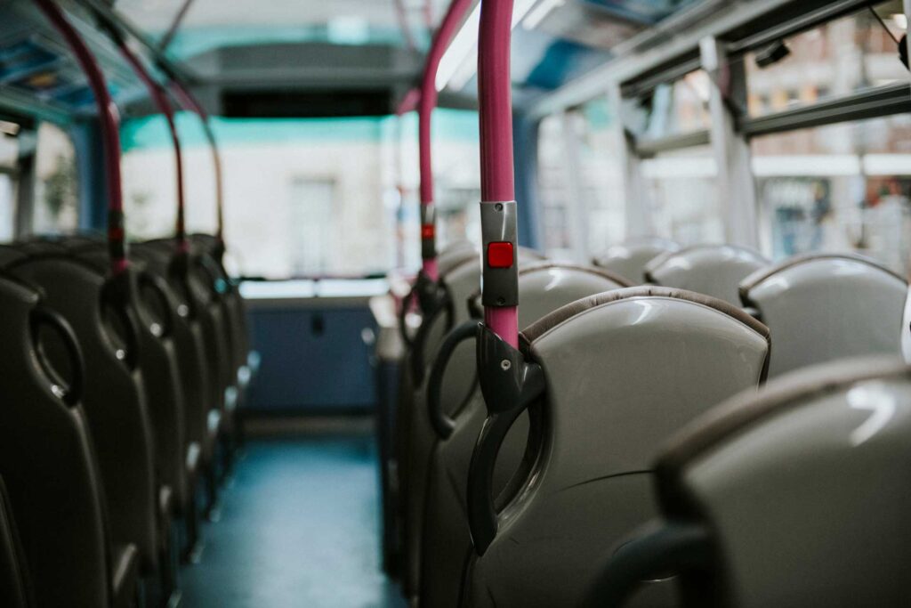 An empty bus with rows of vacant seats, symbolizing the challenge of staying on mission during COVID-19 as communities adapt to new outreach methods.